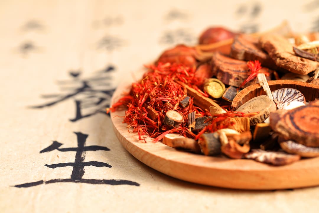 Chinese herbs on a wood plate Chinese herbs on a wood plate