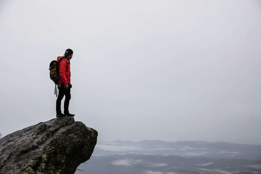 Person standing on gray rock Person standing on gray rock