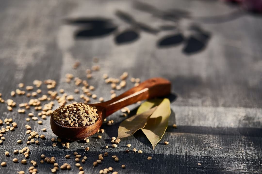 Wooden spoon with herbs on a table Wooden spoon with herbs on a table
